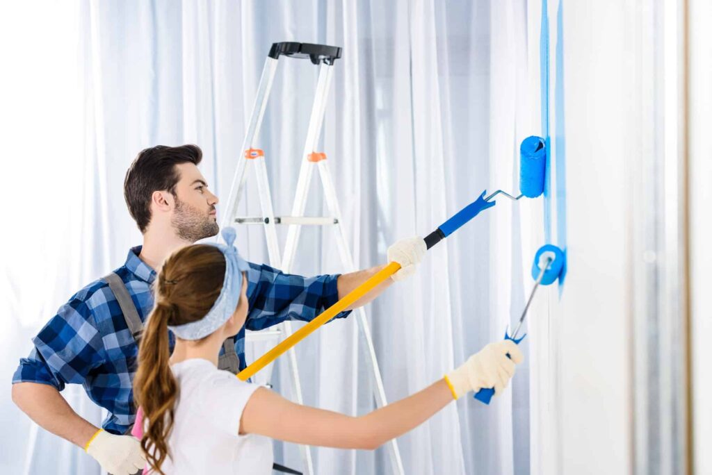 boyfriend-and-girlfriend-painting-wall-with-blue-paint.jpg